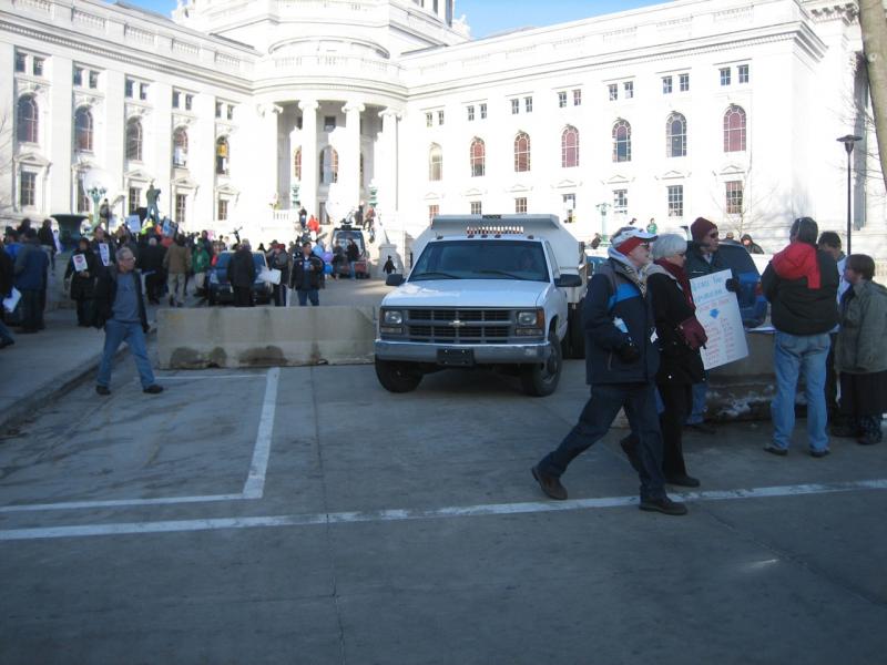 Concrete traffic barriers block the West Washington Ave. driveway to the Capitol