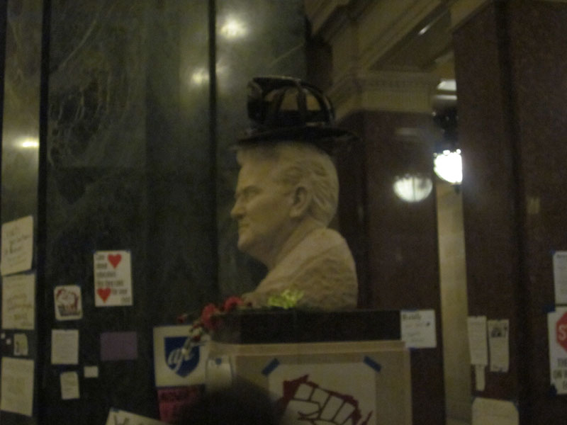 Firefighters helmet atop bust of Fighting Bob La Follette