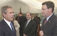 George Bush meets Alexander Downer in Canberra.