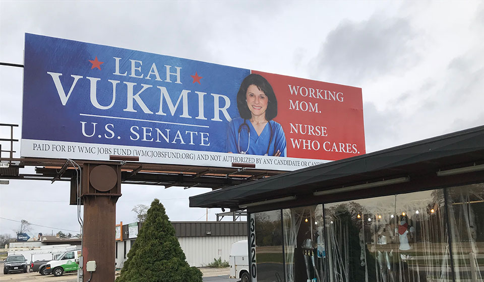 Vukmir billboard over an adult video store