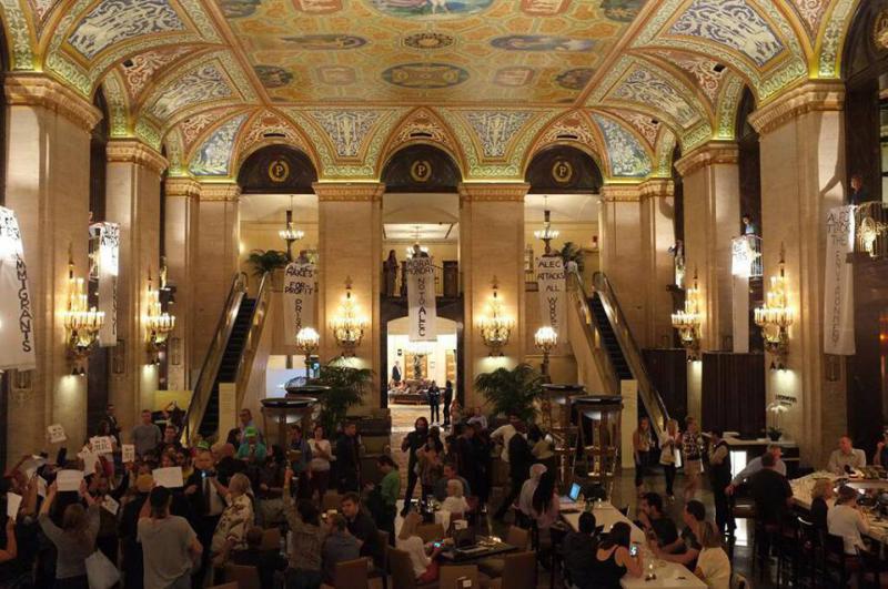 Protestors drop three banners inside the Palmer House Hilton (Source: US Uncut)